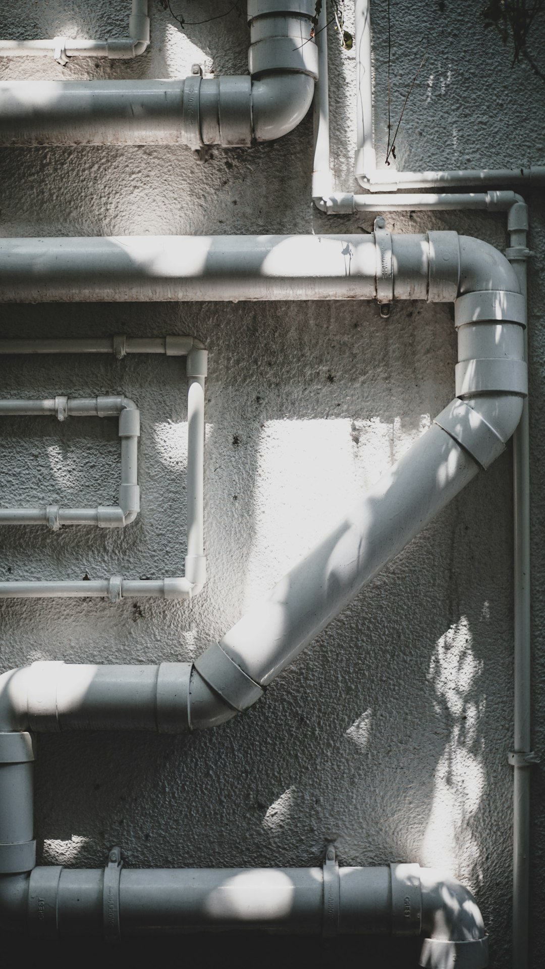 White plastic water pipe under repair in a rented home