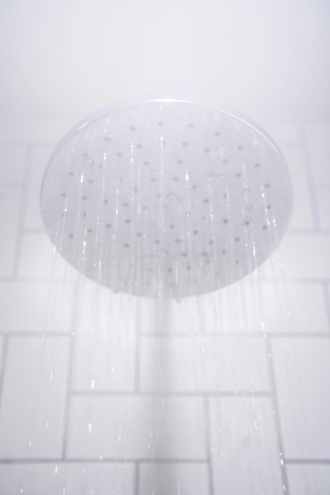 Water flowing weakly from a stainless steel shower head
